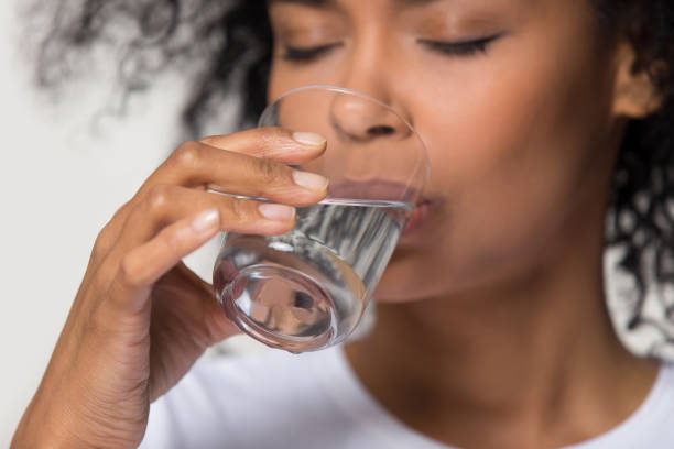 Glass of water on a wooden table in soft daylight