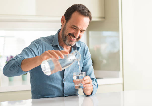 Person pouring water into a travel bottle